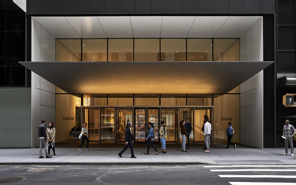 People walking outside modern building entrance